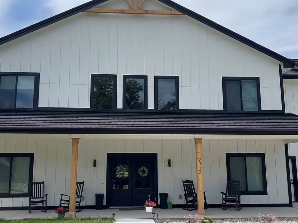 white custom built barndominium with black framing