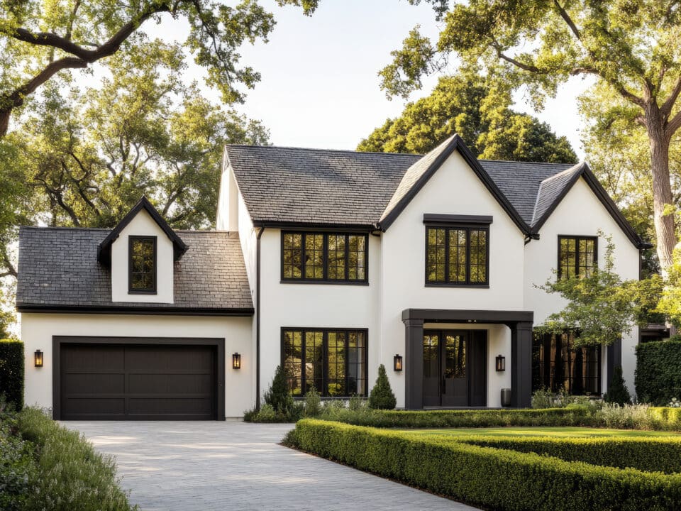 a modern farmhouse style home with a white exterior, black trim, and dark roof shingles.